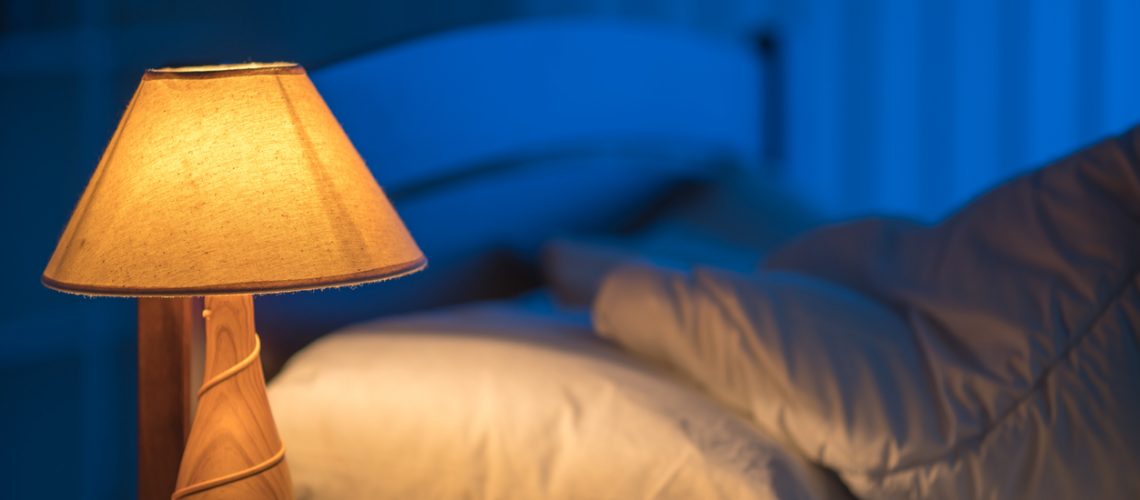 The lamp against the background of the bed. night time
